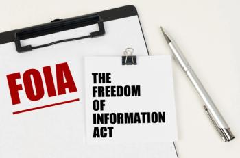 On the tablet, a sheet of paper and stickers with the inscription - FOIA, THE FREEDOM OF INFORMATION ACT | Image Credit: Dzmitry - stock.adobe.com