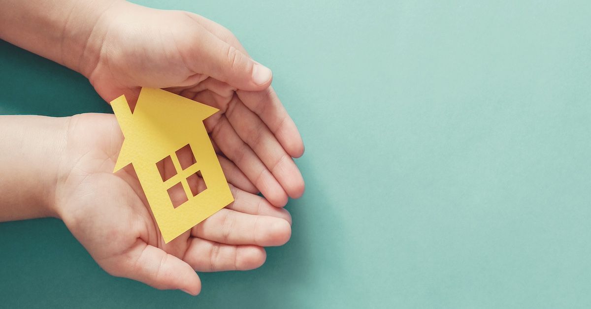 Paper cutout of home in a person's hands | Image Credit: © SewcreamStudio - stock.adobe.com