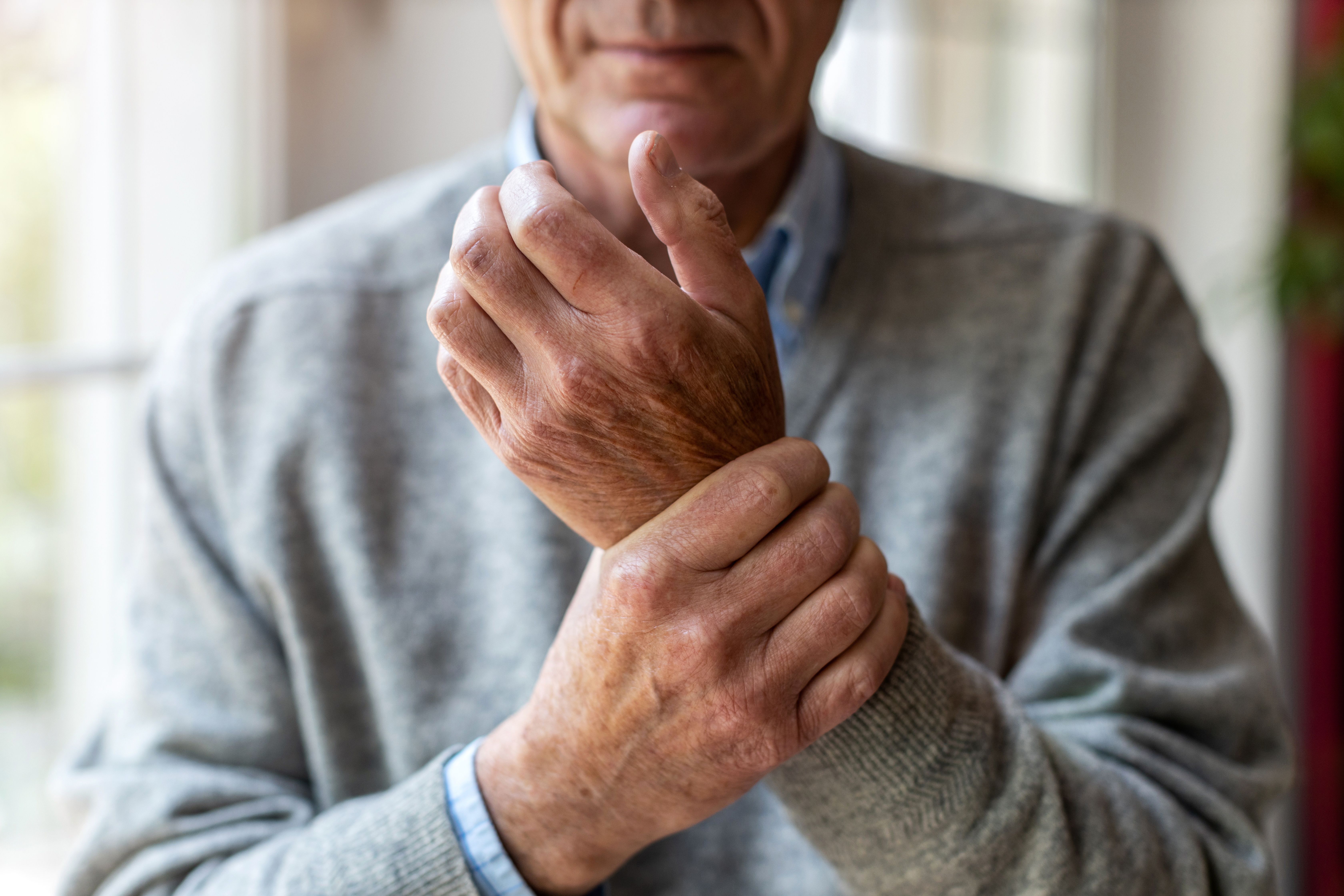 Man rubbing wrist | Image credit: pikselstock - stock.adobe.com