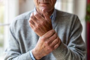 Man rubbing wrist | Image credit: pikselstock - stock.adobe.com