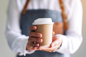 Waiter holding cup of coffee | Image credit: Farknot Architect – stock.adobe.com