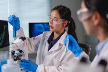 Scientists analyzing blue chemical liquid in test tube in laboratory | Image credit: Phimwilai - stock.adobe.com