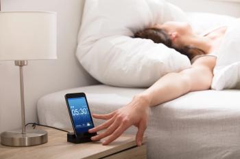 Woman turning off alarm  Image credit: Andrey Popov stock.adobe.com