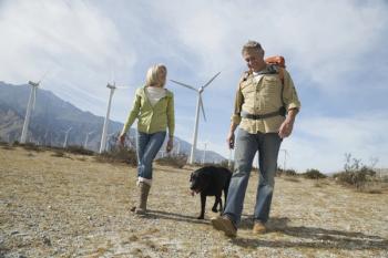 Two people walking with dog.