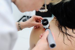 a patient is having their skin examined