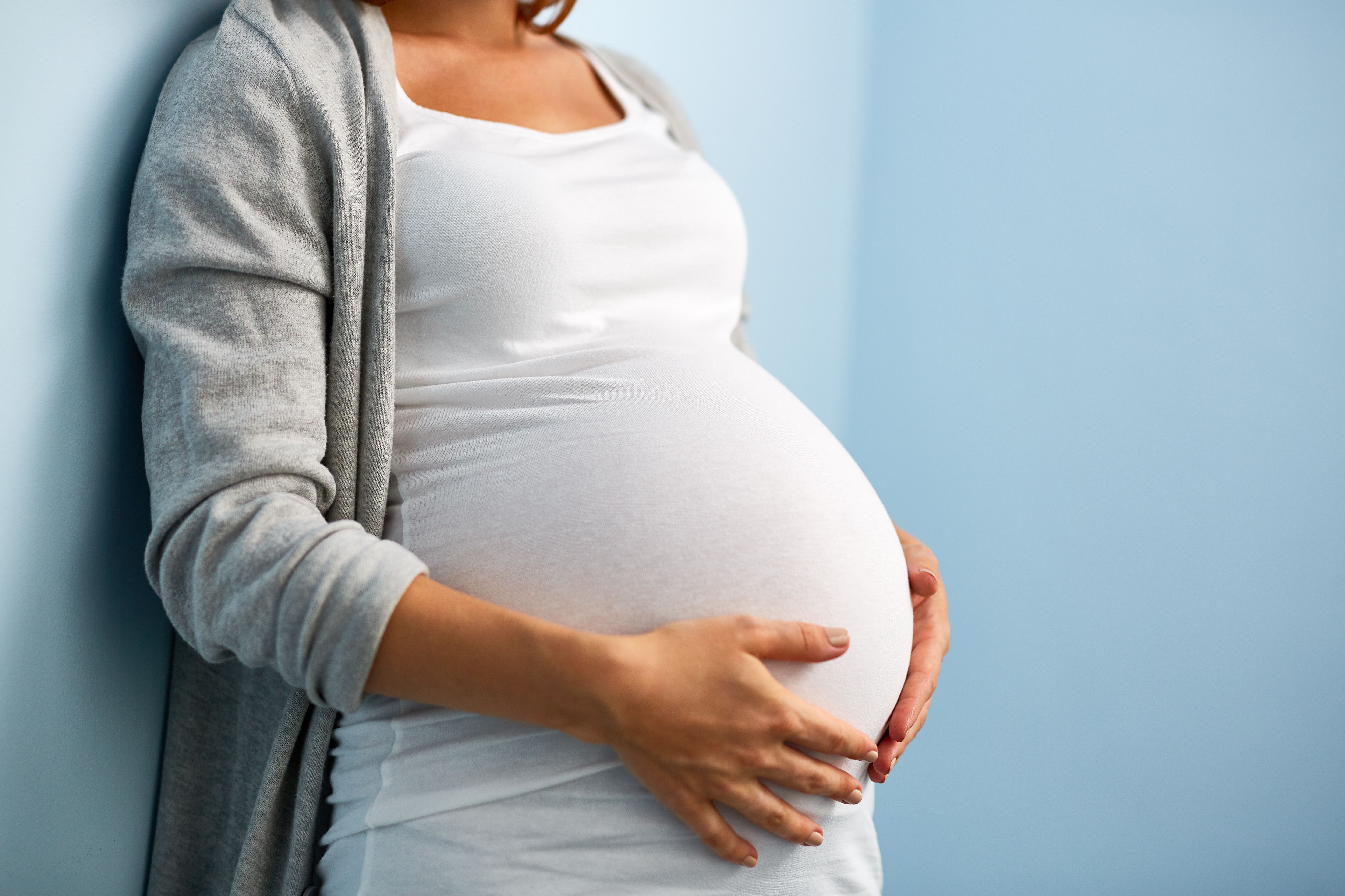 Pregnant woman holding stomach | Image Credit: pressmaster - stock.adobe.com