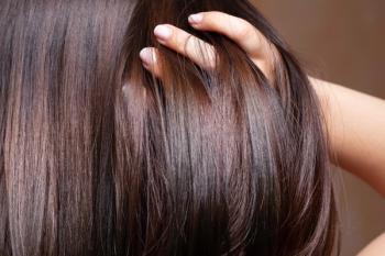 Woman running hand through hair | Image credit: Alessandro Grandini – stock.adobe.com