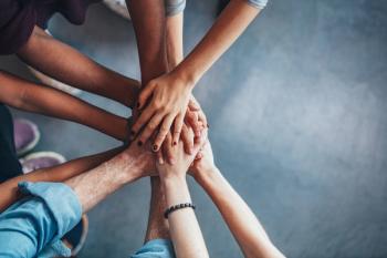Stack of hands showing unity and teamwork: © Jacob Lund - stock.adobe.com