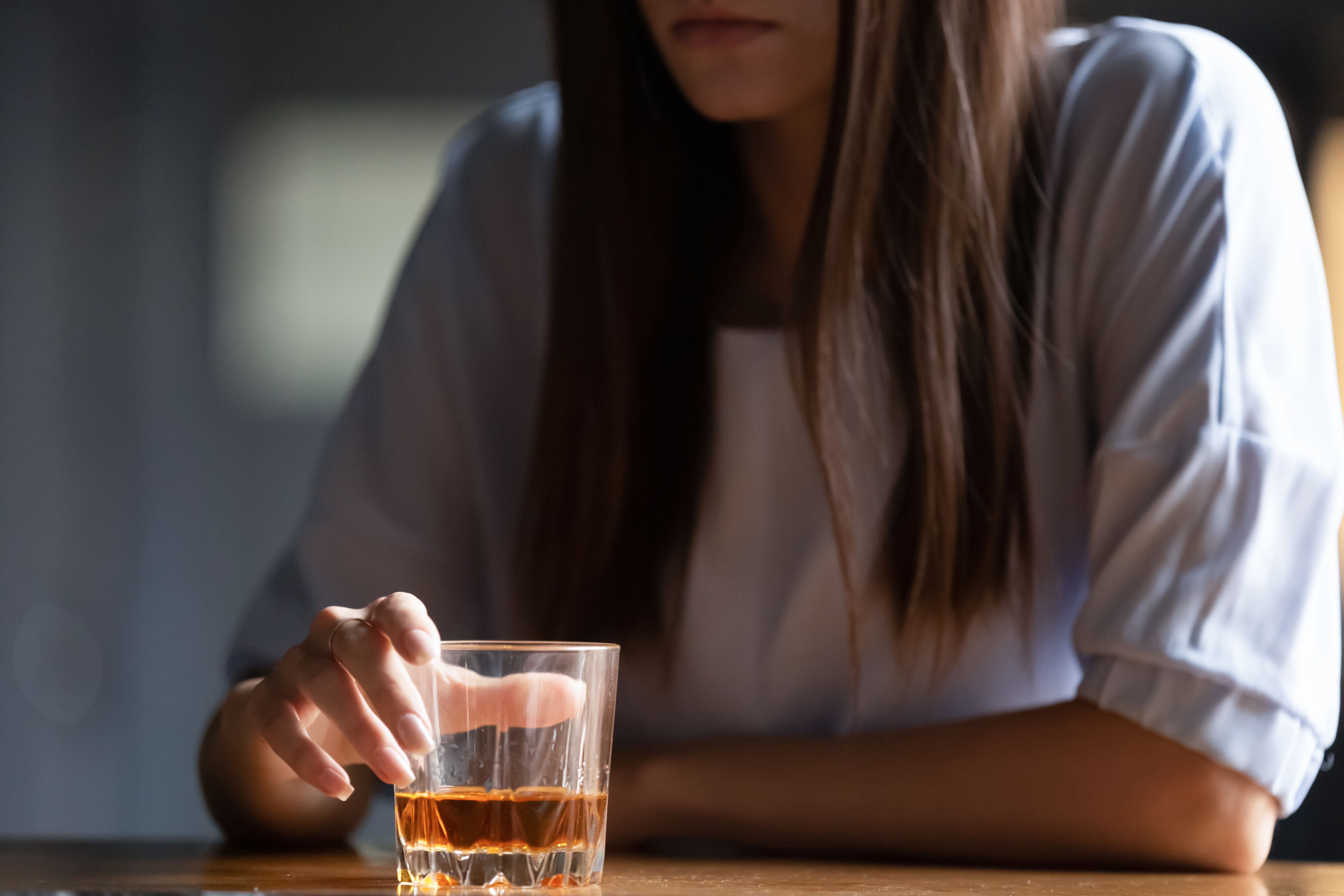 Close up of woman drinking alcohol at bar counter | Image credit: fizkes - stock.adobe.com