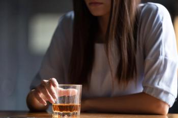 Close up of woman drinking alcohol at bar counter | Image credit: fizkes - stock.adobe.com