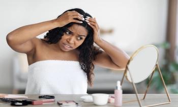  Young black woman with hair concern| Image Credit: Prostock-studio-stock.adobe.com