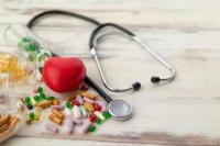 Top view of red heart and medicine on wooden floor | Image credit: Jack Fotografo - stock.adobe.com