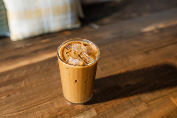 Small glass of iced coffee with ice on a table | Image credit: Wirestock - stock.adobe.com