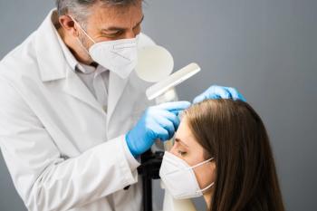 Dermatologist checks patient's scalp, wearing surgical masks | Image Credit: Andrey Popov - stock.adobe.com