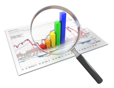 a magnifying glass over a report with a 3D graph on it