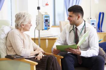 Physician speaking with patient.