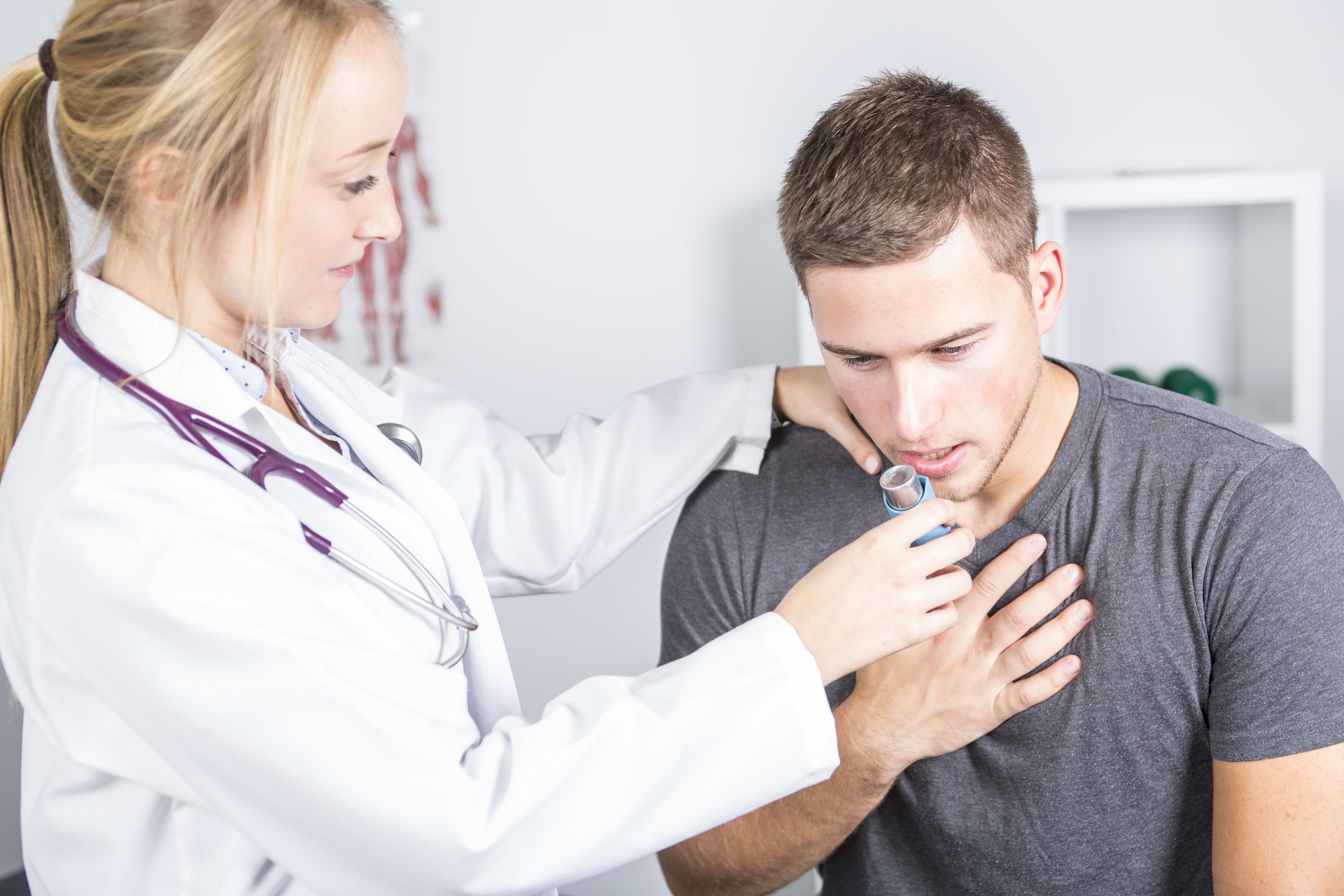 Doctor helping patient with inhaler