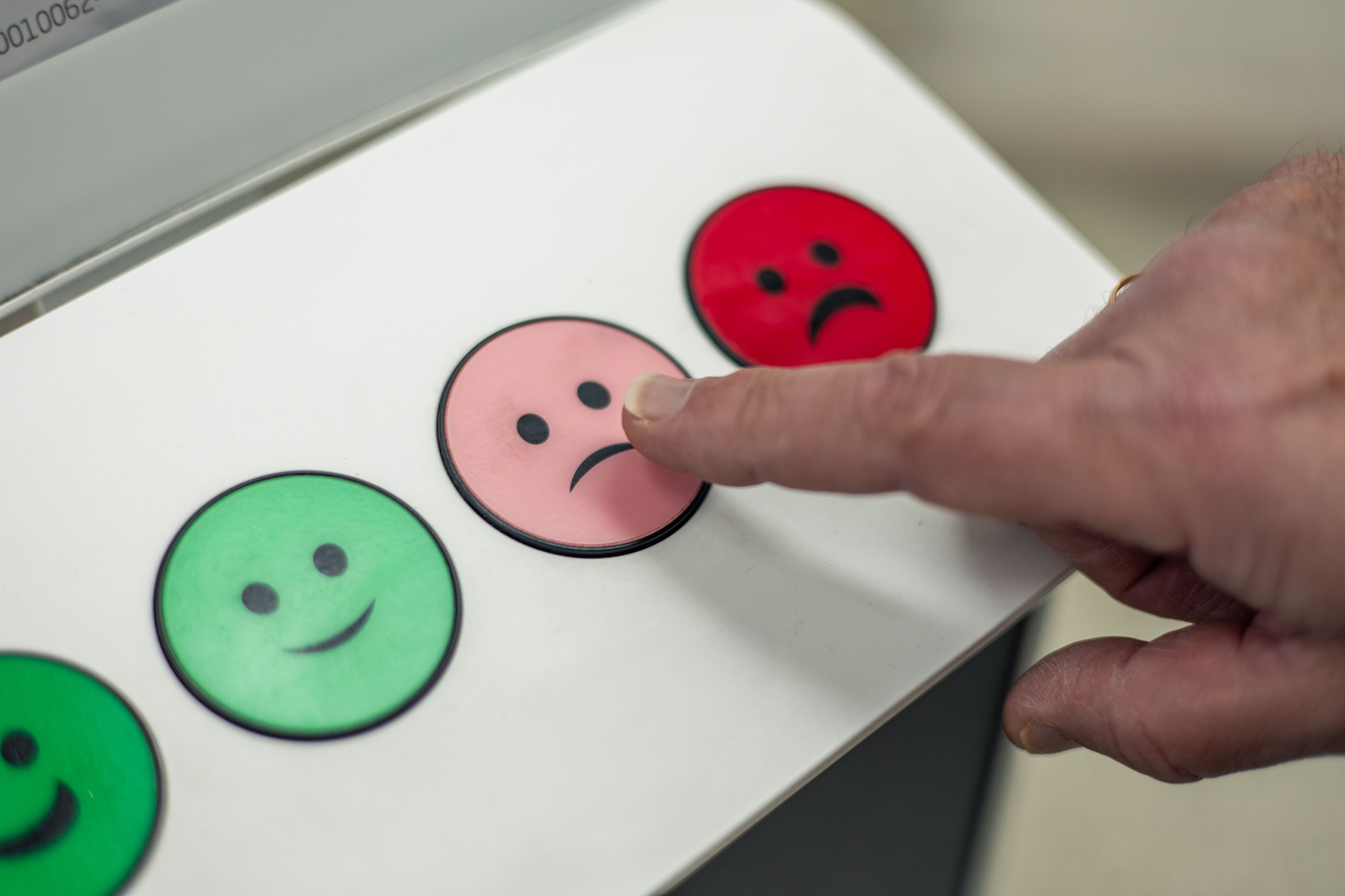 Person pushing button with slight frowning face | Image credit: EDER – stock.adobe.com