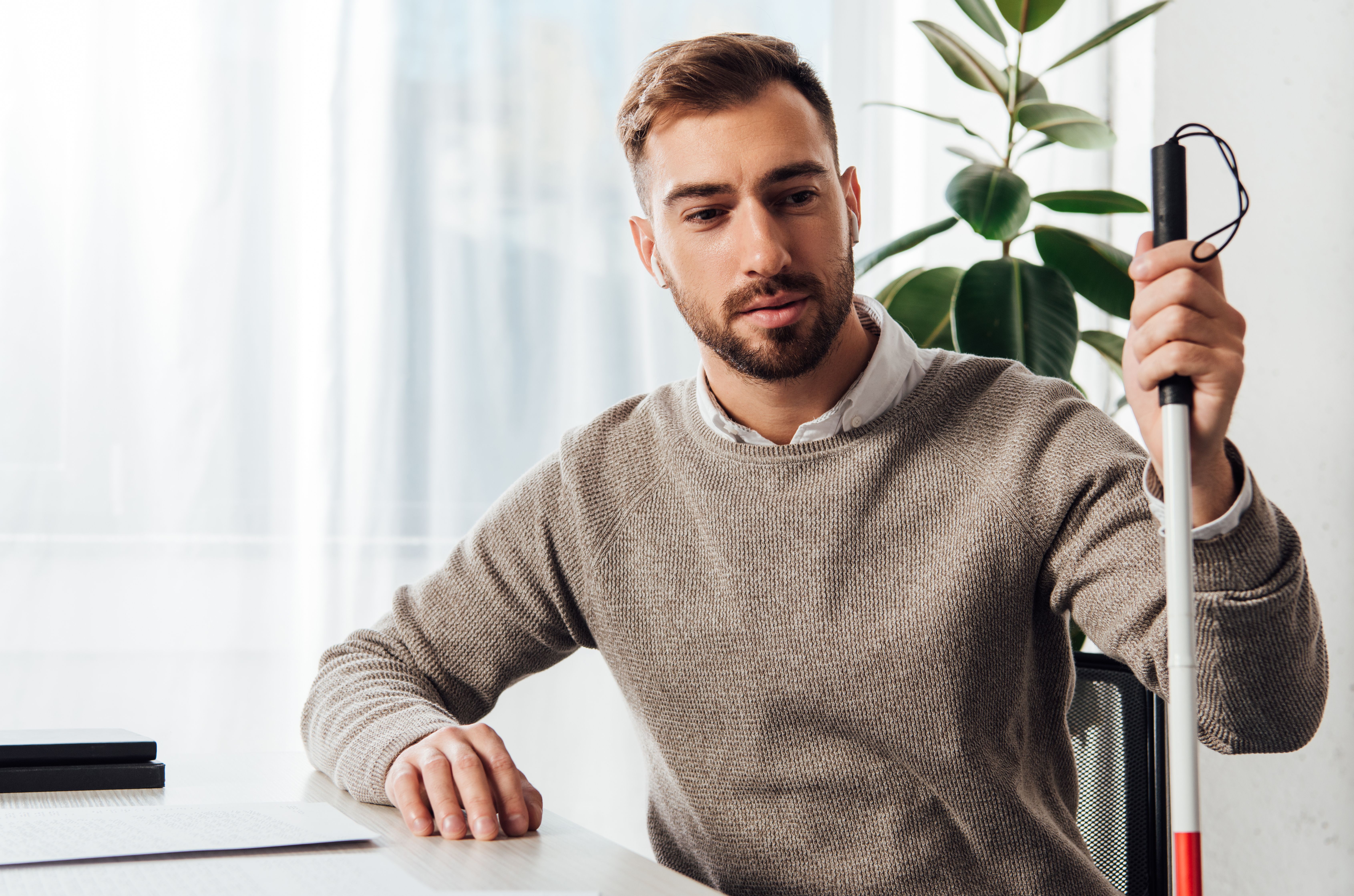 Visually impaired man at table | Image credit: LIGHTFIELD STUDIOS – stock.adobe.com