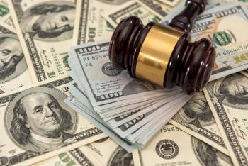 Money with judges gavel on top | Image credit: RomanR – stock.adobe.com