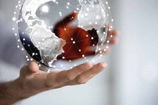 Holding a globe with interconnected nodes | Image Credit: © vegefox.com - stock.adobe.com