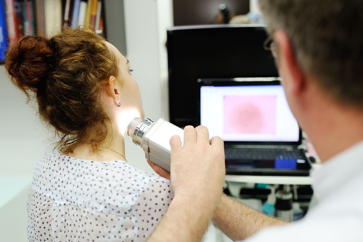 Dermatologist using a dermatoscope