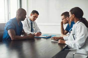Doctors talking around table