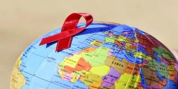 Hiv awareness ribbon on a globe. 