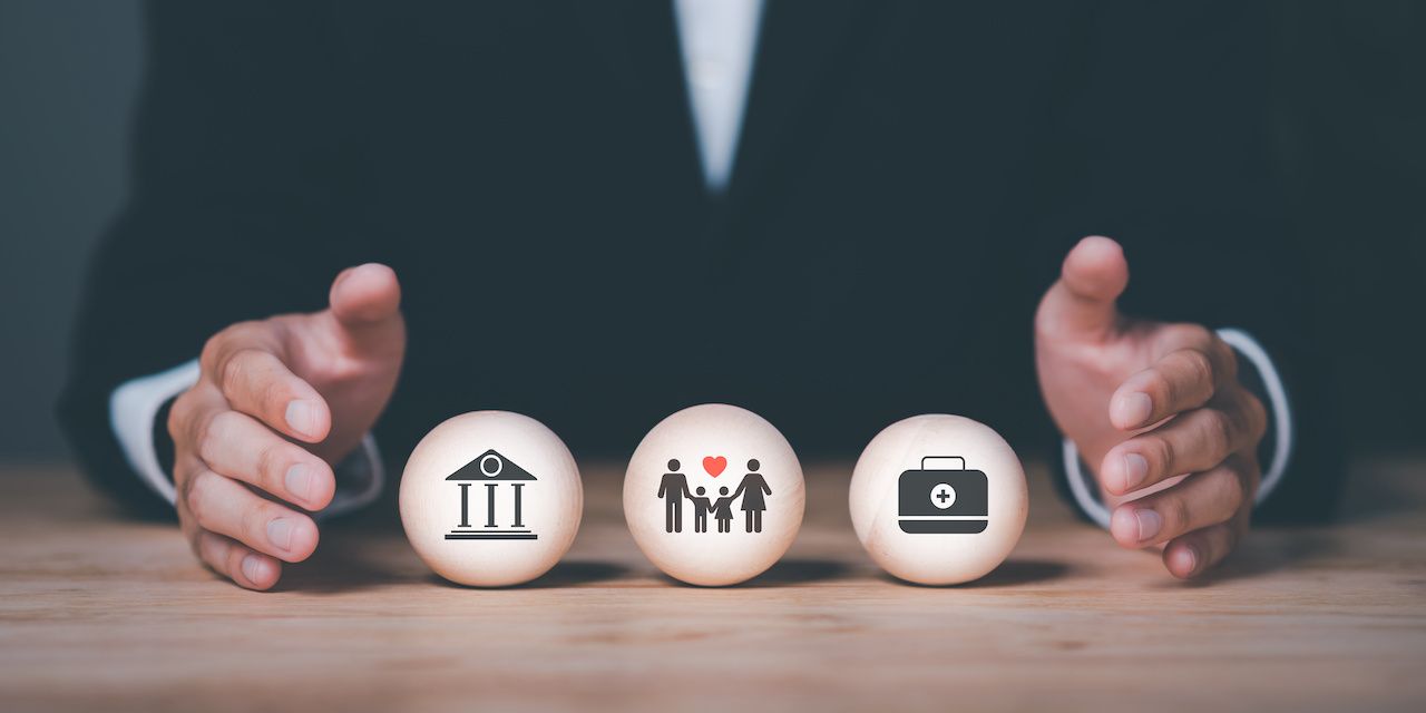 Male hands showing protection and protection for family security, finances and health ,Insurance management planning ,property and family risk reduction ,Caring and caring for loved ones: © chaylek - stock.adobe.com