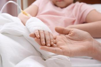 Doctor holding child's hand with intravenous drip | Image Credit: © New Africa - stock.adobe.com