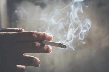 Hand holding smoking cigarette | Image credit: methaphum – stock.adobe.com