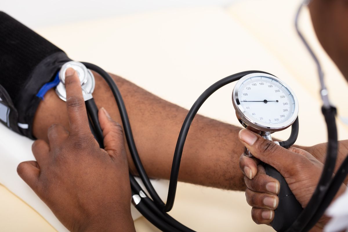 Measuring blood pressure of Black patient | Image Credit: © Andrey Popov - stock.adobe.com