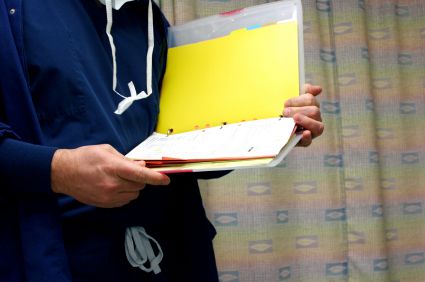 nurse holding and reading binder