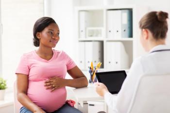 doctor with tablet pc and pregnant woman at clinic | Image credit: Syda Productions – stock.adobe.com