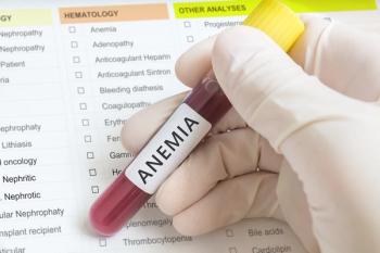 Image of a lab tech with a test tube labelled "anemia": vchalup - stock.adobe.com