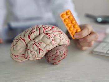 Doctor presenting brain model and medication | Image Credit: Nadzeya - stock.adobe.com