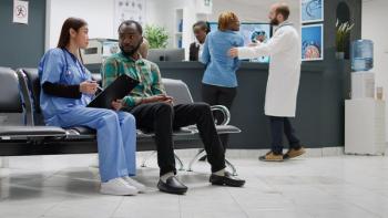 Nurse talking to Black patient in waiting room | Image credit: DC Studio - stock.adobe.com