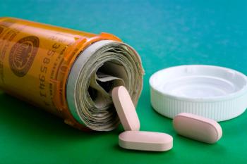Orange pill bottle filled with money | Image credit: Mark Aplet - stock.adobe.com