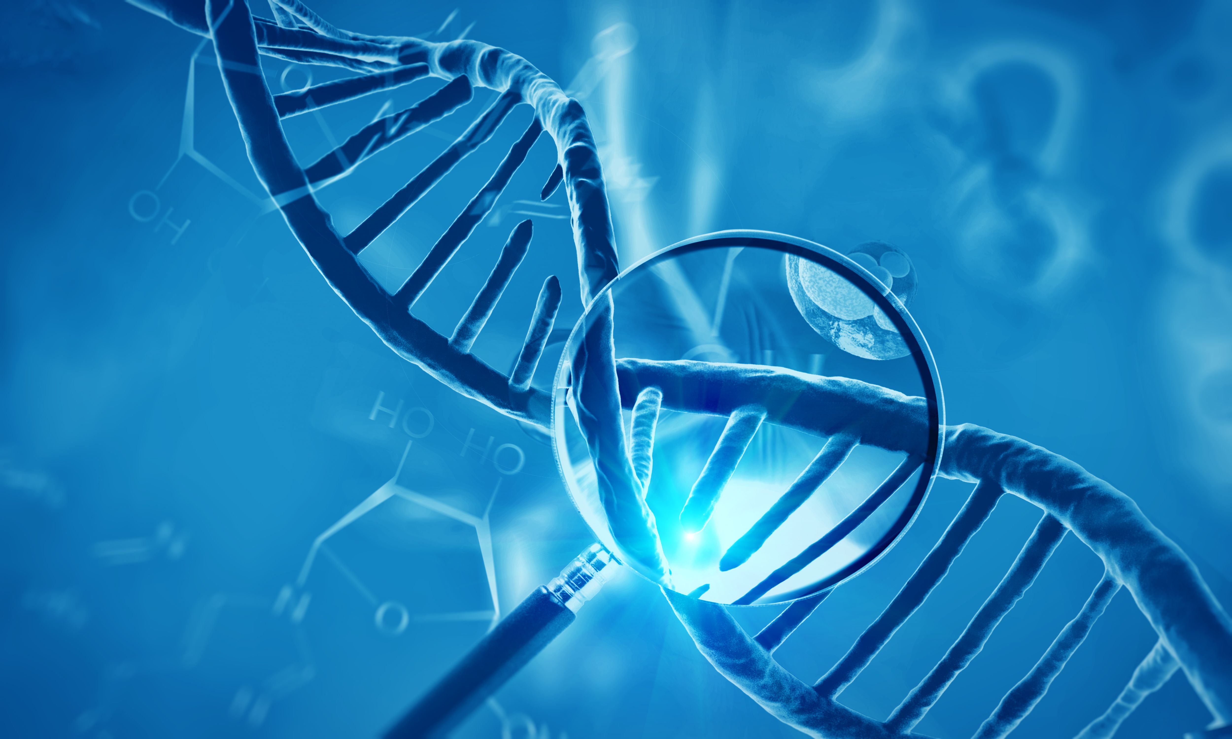 magnifying glass over a model of DNA