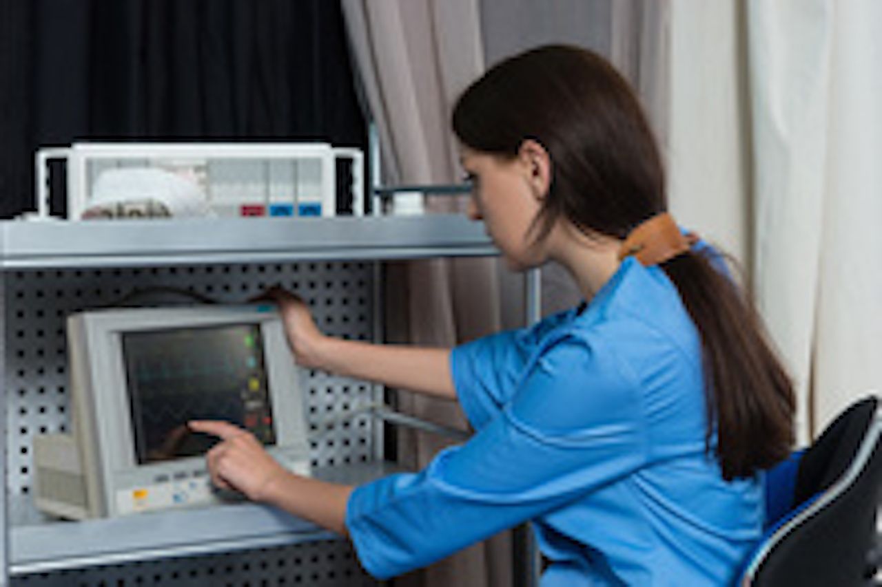 Image of a doctor looking at a heart readout