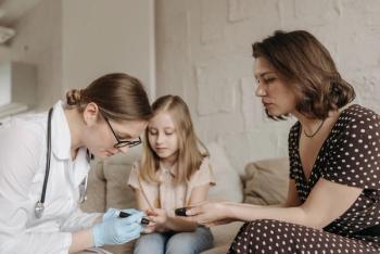 mother, female doctor helping female child with diabetes care