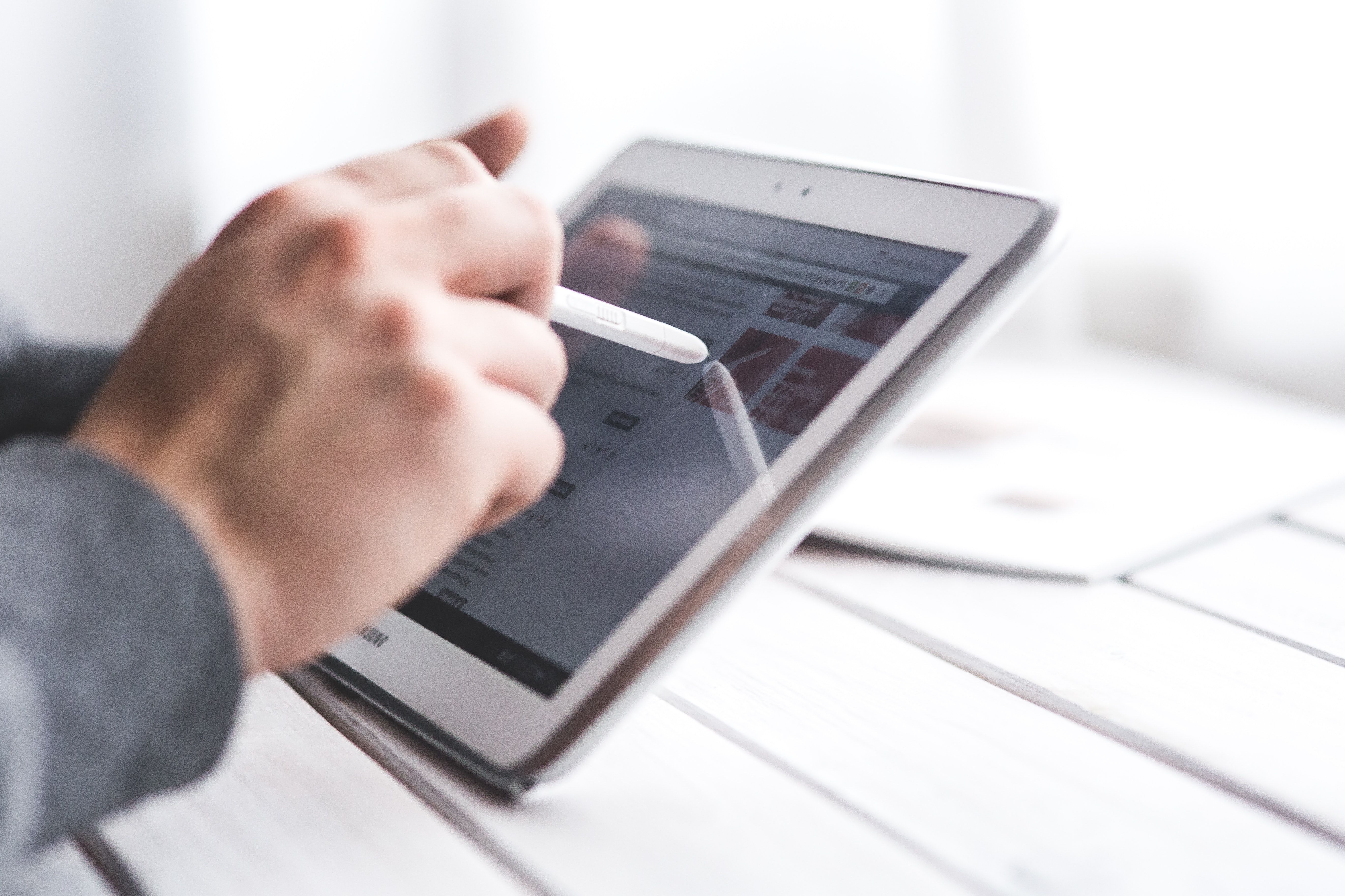 man using a tablet device with a stylus