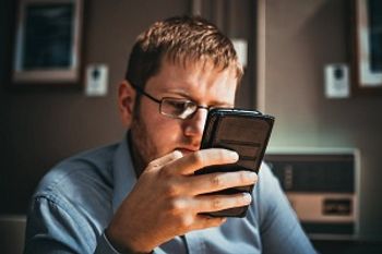 image of man using smartphone