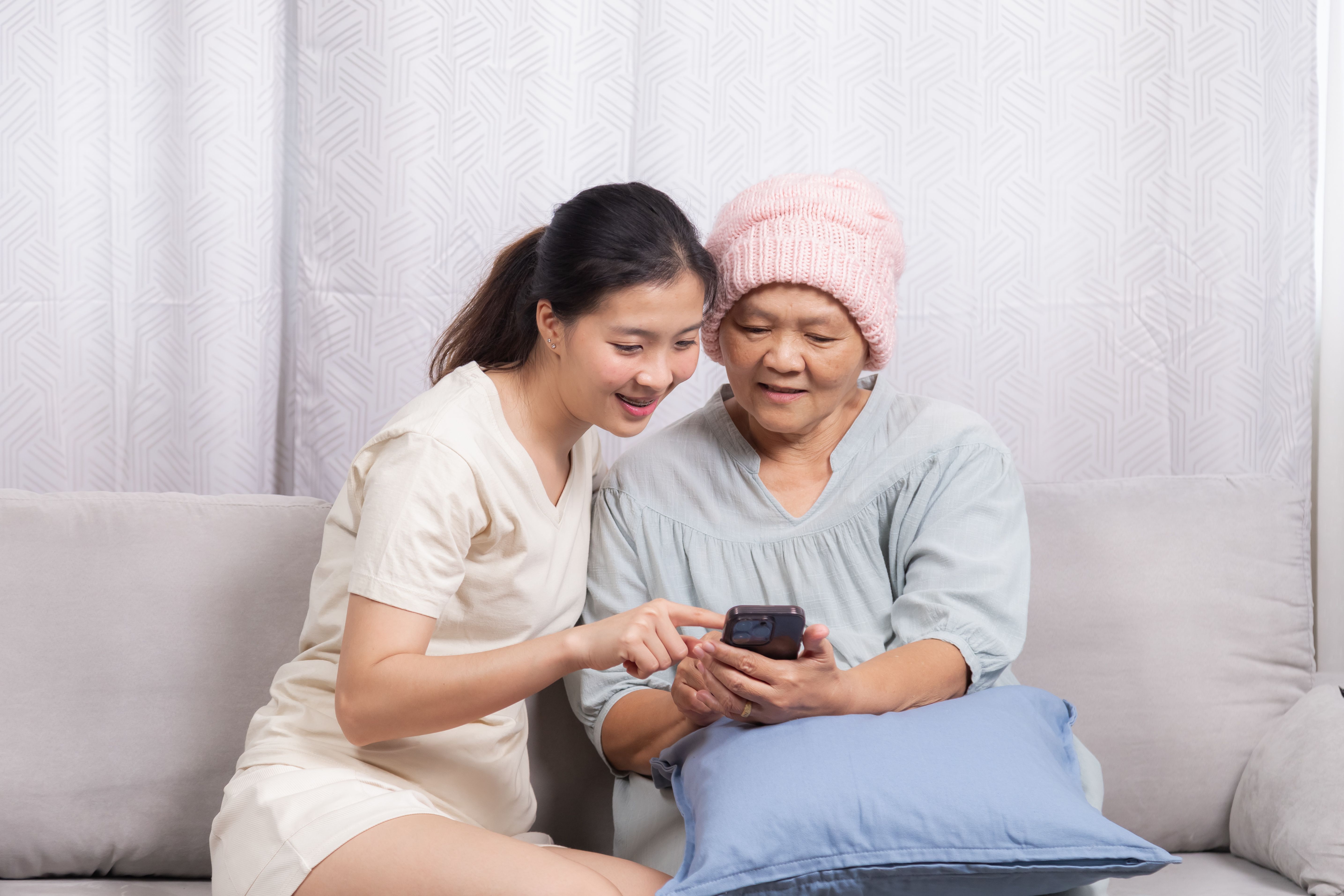 Patient with breast cancer using mobile app to track symptoms. | Image Credit: Rakchanok - stock.adobe.com