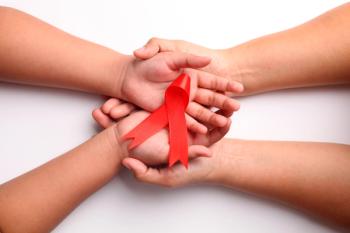 Woman and child holding red ribbon | Image credit: ArvStd - stock.adobe.com