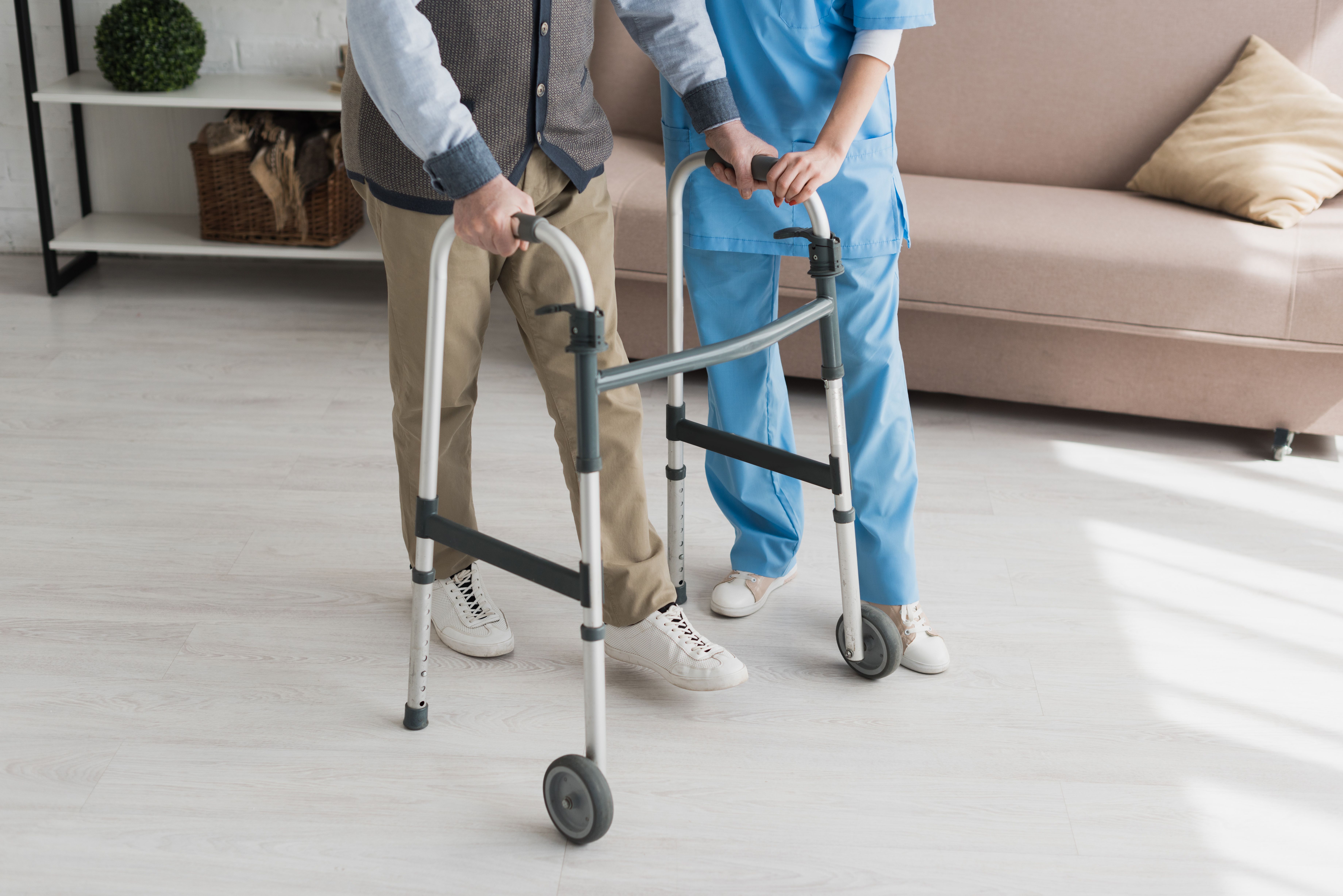 Nurse helping patient use walker | Image credit: LIGHTFIELD STUDIOS – stock.adobe.com