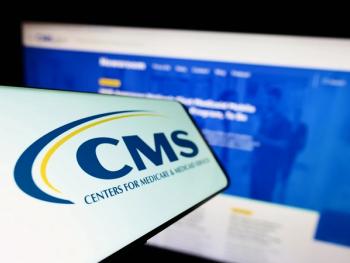 CMS logo on a screen in front of a computer on the CMS website | Image credit: Timon - stock.adobe.com