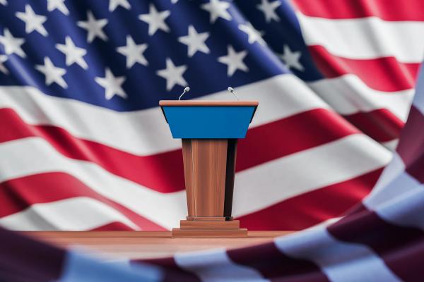 Election debate table over USA flag background - ImageFlow - stock.adobe.com.jpeg