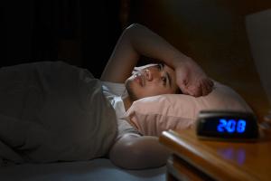 Depressed man suffering from insomnia lying in bed | Image credit: amenic181 - stock.adobe.com