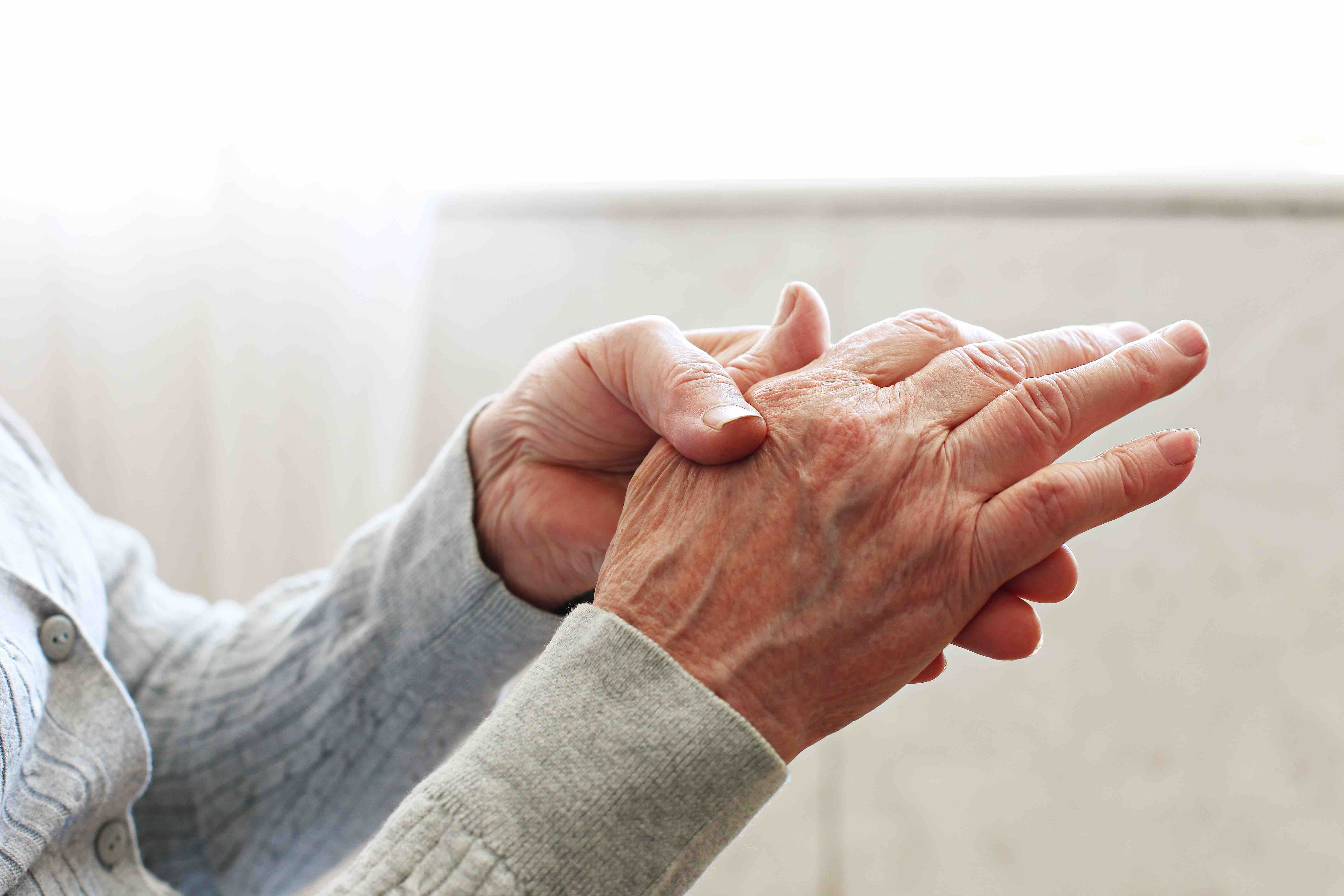 Patient rubbing sore hands with rheumatoid arthritis | Image credit: Evrymmnt - stock.adobe.com